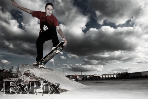 skatebaorder grabbing board on makeshift skatepark in rochdale