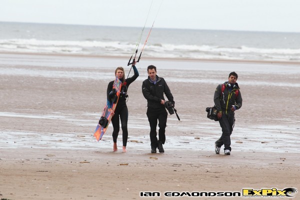 Hannah whiteley walking off the beach with BBC film crew